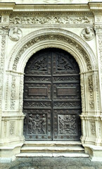 Wall Mural - gate of a temple or city hall of Seville, with a carved wooden doon and ornated arch