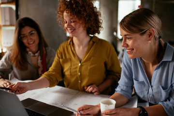 Wall Mural - Businesswomen working on a new project. Colleagues discussing about problem they have to solved..