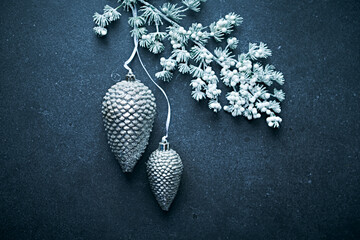 Wall Mural - An arrangement of white and silver Christmas decorations on dark background. Flat lay. Copy space