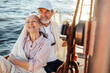 © Artem Varnitsin - Happy mature couple enjoying their vacation on a sailboat