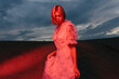 © Cavan Images - woman at sunset illuminated by red light