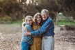 © Cavan Images - Portrait of Adult Woman and Senior Parents Hugging at Park