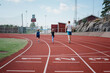 © Cavan Images - father running with his kids on a race track