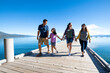 © Cavan Images - A family walks on a pier on a beautiful day in South Lake Tahoe, CA