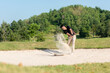 © freebird7977 - Asia Golfer man hitting out of a sand trap. The golf course is on the sand.  Hobby in holiday and vacations on club golf.
