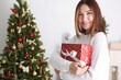 © White bear studio  - beautiful young woman in a Christmas interior with gifts. Place for text, festive background