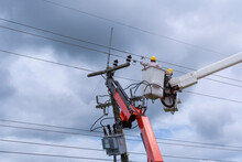 Electrician Works On Bucket Car To Maintenance High Voltage Transmission Lines.