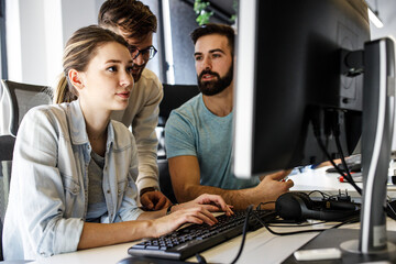 group of designers programmers working on a new project at the office.