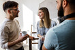 © BalanceFormCreative - Group of casual business people  standing in office and joying in coffee break.