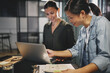© Flamingo Images - Smiling businesswomen working together on a laptop in an office