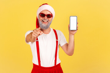 Wall Mural - extremely happy cheerful grey bearded man in santa claus costume pointing finger at camera showing s