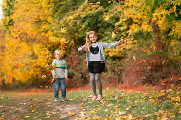 Sticker - Happy little kids with autumn leaves in the park