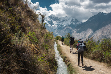 tourists hiking on the way to machu picchu by the salkantay trek, peru