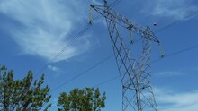High Voltage Transmission Line Tower On Blue Sky