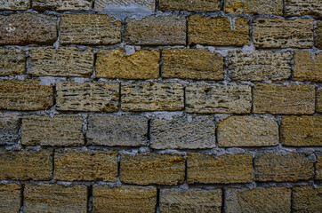 The wall is made of Crimean sandstone. Background and texture.