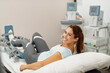 © Drazen - Happy woman having leg rehabilitation therapy with arthromot device at health spa.
