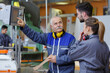 © auremar - team of engineers having discussion in factory
