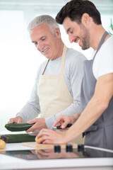 Wall Mural - two men prepare a meal together