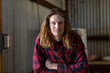 © Caro Telfer/Austockphoto - long-haired guy in red-checked shirt looking at camera