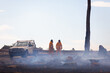 © Caro Telfer/Austockphoto - two fire service volunteers with vehicle in burnt out landscape with smoke