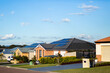 © Clare Seibel-Barnes/Austockphoto - Neat houses along quiet suburban street in town
