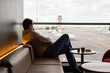 © Gillian Vann/Austockphoto - man using phone whilst waiting in airport lounge