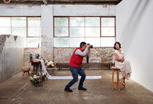 Photographer and model at styled wedding photoshoot