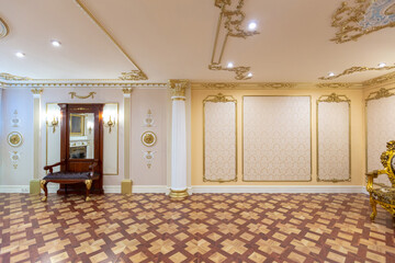 luxurious living room interior with beautiful old carved furniture of gold color with decorations on the walls in the style of the royal palace