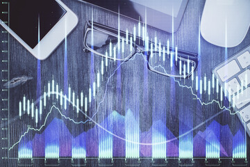 Multi exposure of forex graph hologram over desktop with phone. Top view. Mobile trade platform concept.