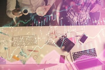 Wall Mural - Double exposure of man and woman working together and financial chart hologram drawing. market analysis concept. Computer background. Top View.