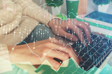 Double exposure of woman hands typing on computer and forex chart hologram drawing. Stock market invest concept.