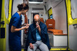 © Anna Kosolapova - A nurse with a stethoscope examining an injured man in an oxygen mask.