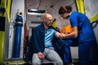 © Anna Kosolapova - Injured man in a blanket is getting first aid in an ambulance car.