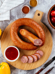 Canvas Print - fresh homemade sausage on a light background with vegetables