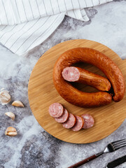 Wall Mural - fresh homemade sausage on a light background with vegetables