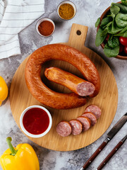 Wall Mural - fresh homemade sausage on a light background with vegetables