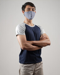 Young men in empty T-shirts and wearing health masks, dress up and pose like famous T-shirt models. Men's t-shirt template and mockup design for print.