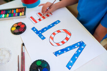 Close-up Of A Child Girl Drawing The Word Vote. Vote Symbol In The American Elections. Political Activity