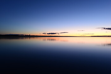 Wall Mural - Calming twilight blue sky over calm purity water lake  dusky dreamlike silence of nature