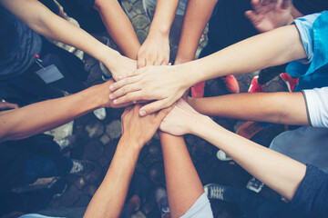 Wall Mural - Solidarity unite people hands together community teamwork. Hands of spirit team working together outdoor. Unity strong handshake with people or agreement of feeling or happy diverse education action