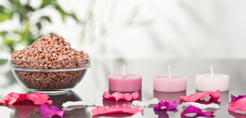 Canvas Print - A bowl of brown gravel with pink petals and candles