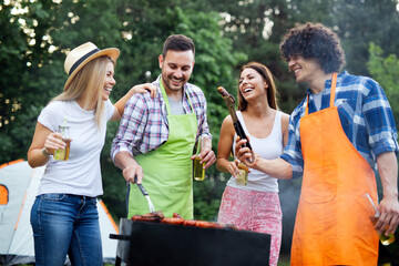 Friends having fun in nature doing bbq