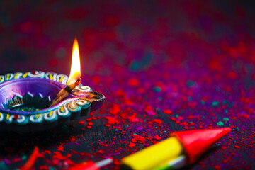 Canvas Print - Diwali Diya with Fire Crackers over rangoli background