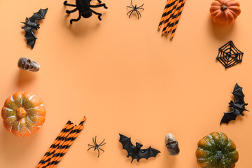 Wall Mural - Halloween frame of fun party decorations, pumpkins, drinking straw, bat, skulls, spooky spider on orange background. Overhead view, flat lay. Copy space.