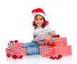 Little girl in Santa's hat with gift box