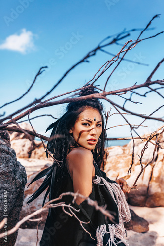 Plakat beautiful young stylish tribal woman outdoors on the beach