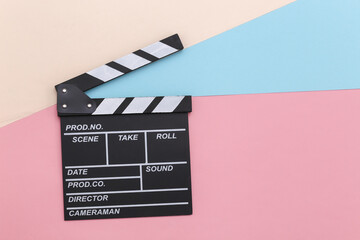 Sticker - Movie clapper board on colored pastel background. Cinema industry, entertainment. Top view