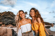 © zolotareva_elina - two beautiful young stylish woman on the beach at sunset