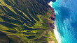 © ZHAO YOULI - Aerial Na Pali Coast, Kauai Hawaii. These emerald-hued cliffs with razor-sharp ridges tower above the Pacific Ocean, revealing beautiful beaches and waterfalls that plummet to the lush valley floor.