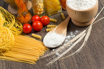 Wall Mural - pasta, tomatoes and flour on the spoon